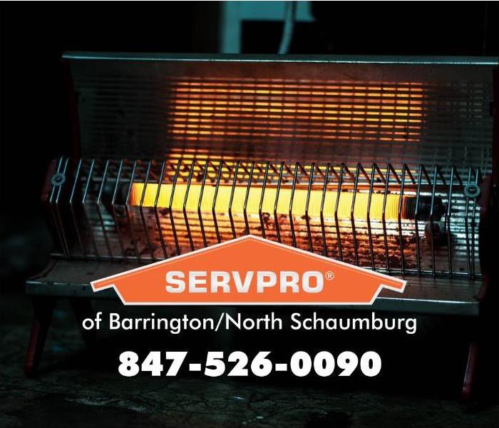 Hot space heater with a metal cage with a SERVPRO logo.