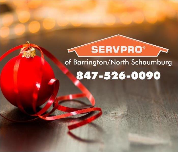 Red ornament with a red ribbon and an orange SERVPRO logo.