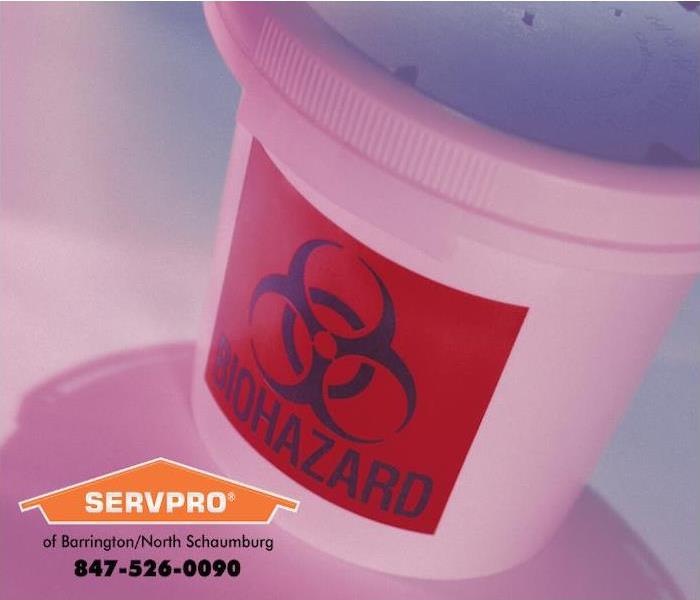 A large container labeled “Biohazard” is tipped at an angle and could fall over and spill at any time. 